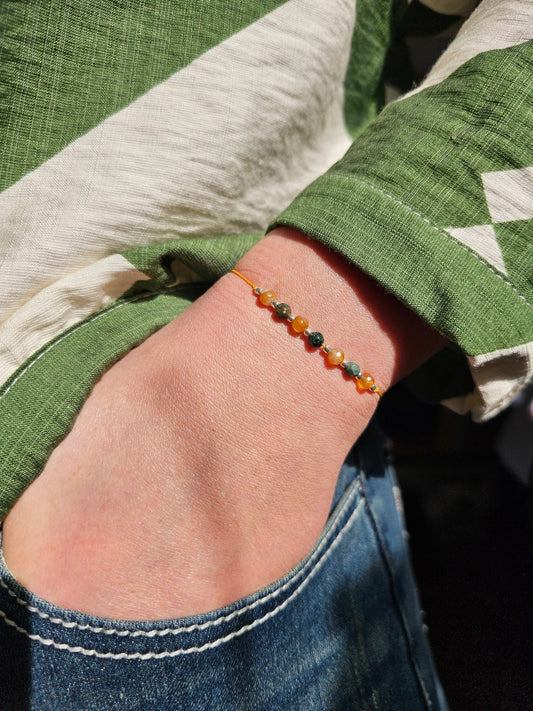 Handmade agate earth bracelet with natural stones and sterling silver beads. Adjustable cord for comfort. Grounding and protective jewelry, crafted in Ireland.