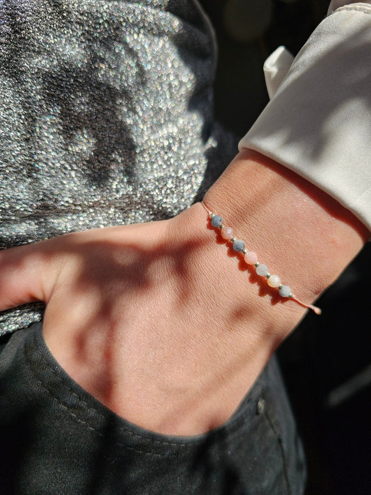 Handmade aquamarine and pink opal bracelet with sterling silver beads. Adjustable cord for comfort. Natural gemstone jewelry promoting calm, love, and creativity.