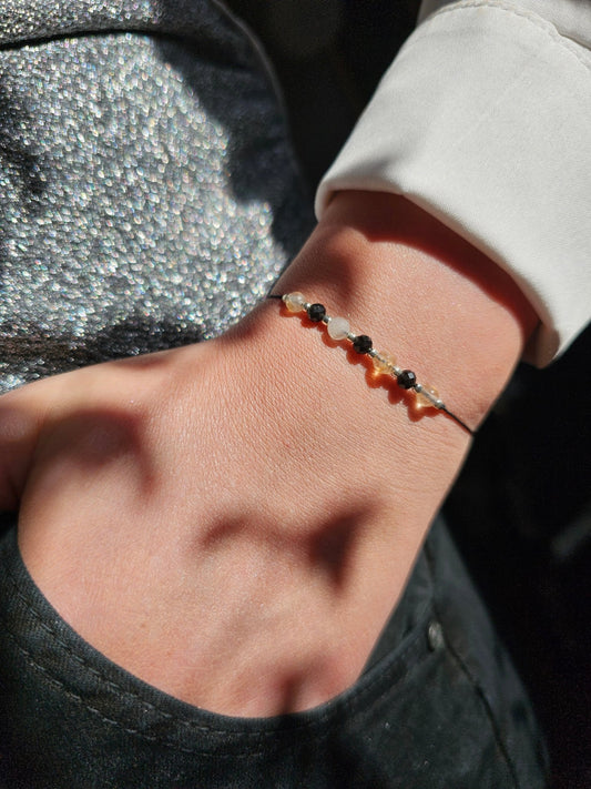 Handmade citrine and onyx bracelet with sterling silver beads. Adjustable cord for comfort.