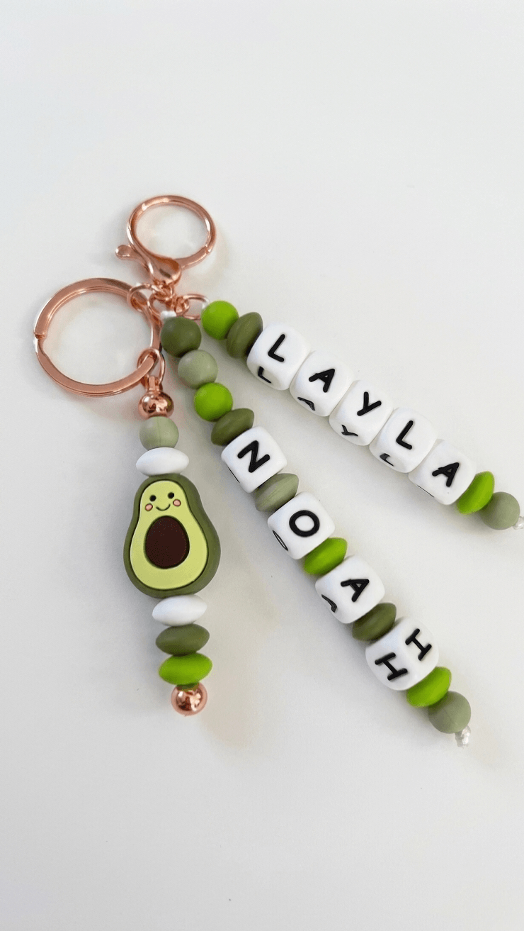 Custom kids name tag made of soft silicone beads attached to a colourful school backpack.