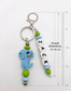 Personalised boy's backpack name tag made of colourful BPA-free silicone beads with a sturdy metal clasp, attached to a school bag zipper as a custom identifier.