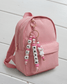 Handcrafted, personalized charm made from BPA-free soft silicone in shades of pink and white. It features three strands: two with name beads and one with a cute white llama figurine with a pink rose, all attached to an elegant rose gold clasp.