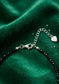 Close up of a trendy coquette bow made of 3mm faceted black tourmaline beads with solid silver accents.