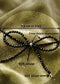 Elegant protective crystal jewelry featuring a dainty black tourmaline ribbon design on a white background.