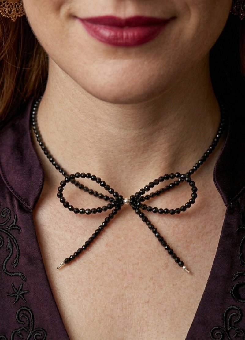 Handmade black tourmaline choker necklace with a delicate beaded bow and 925 sterling silver finish.