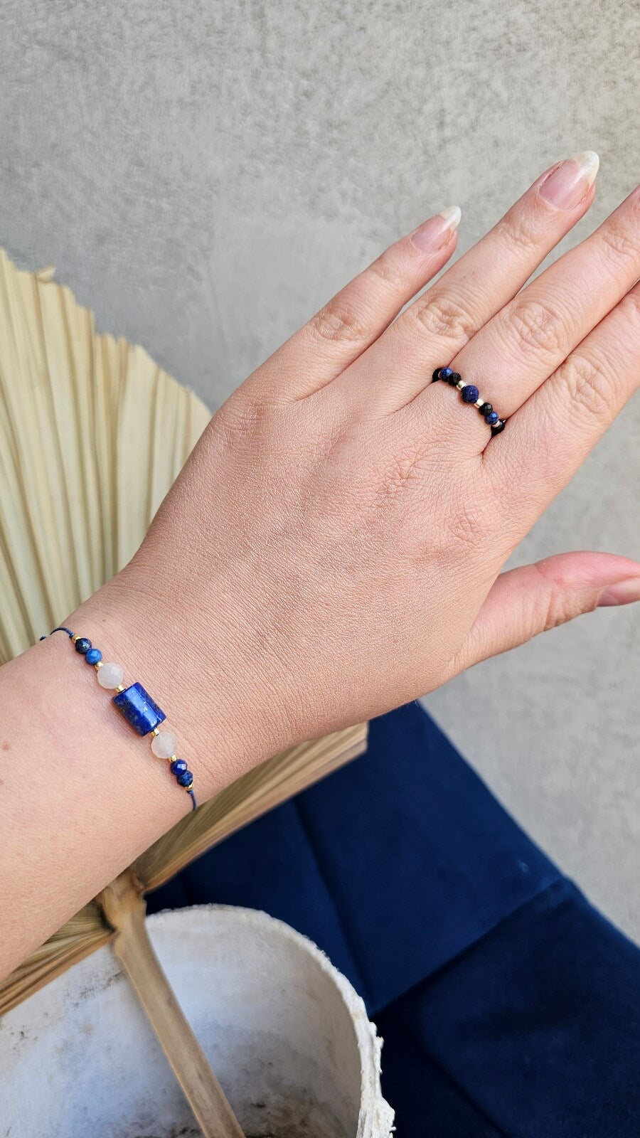 Three handmade elastic gemstone rings with Lapis Lazuli, Black Tourmaline and Moonstone beads, featuring gold and silver accents on a minimalist background.