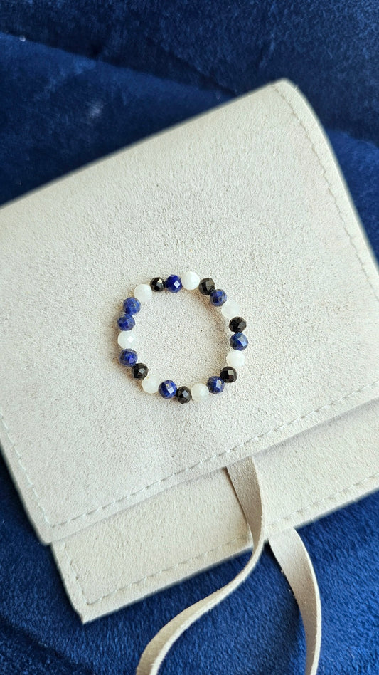 Trio of handmade elastic gemstone rings featuring Lapis Lazuli, Black Tourmaline, and Moonstone beads with gold accents, handmade in Ireland.