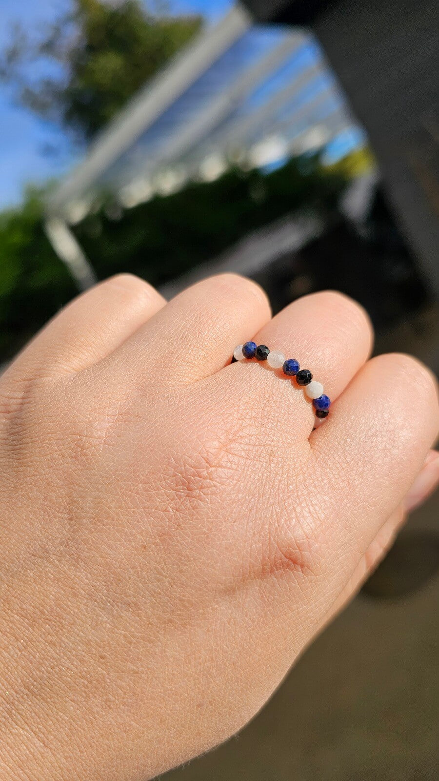 Trio of handmade elastic gemstone rings featuring Lapis Lazuli, Black Tourmaline, and Moonstone beads with gold accents, handmade in Ireland.