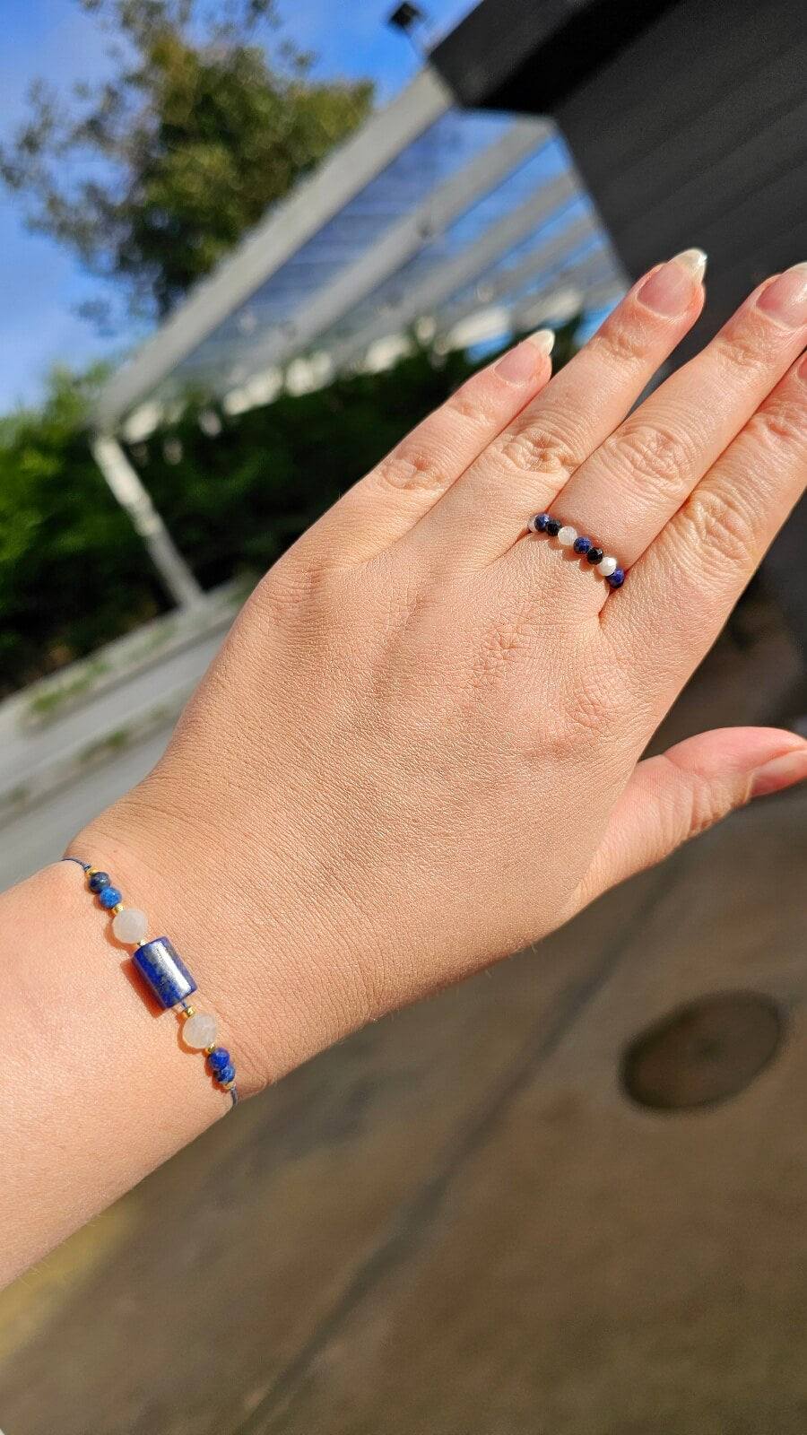 Person wearing stackable Lapis Lazuli and Black Tourmaline elastic rings for a minimalist boho jewelry look.