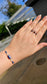 Person wearing stackable Lapis Lazuli and Black Tourmaline elastic rings for a minimalist boho jewelry look.