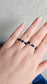 Person wearing stackable Lapis Lazuli and Black Tourmaline elastic rings for a minimalist boho jewelry look.