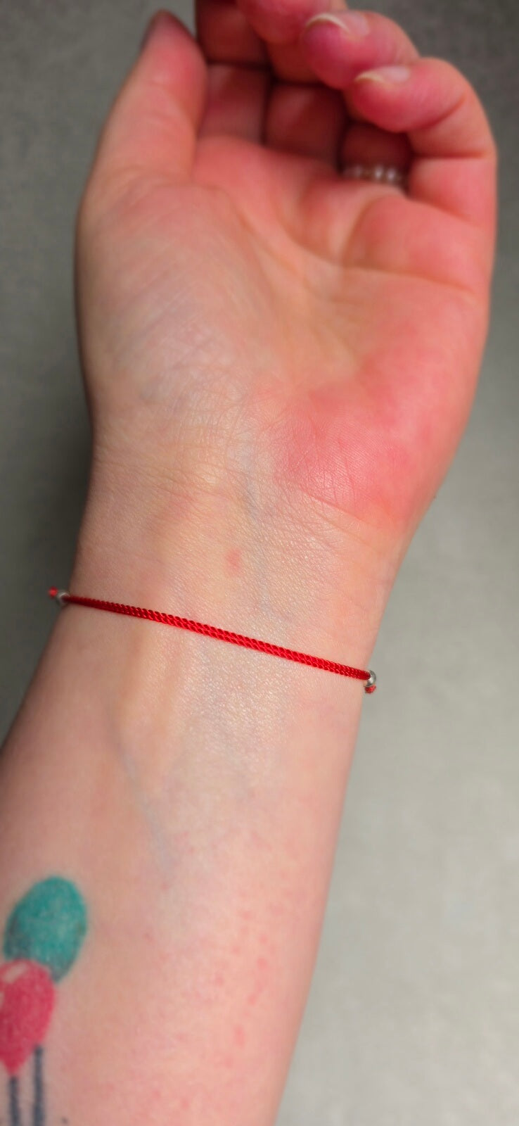 Adjustable 925 sterling silver slider beads on a red lucky charm bracelet for a perfect fit.