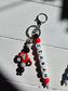 Close-up of a handmade personalised charm showing letter beads, soft-touch silicone beads, and a premium rose gold metal attachment.