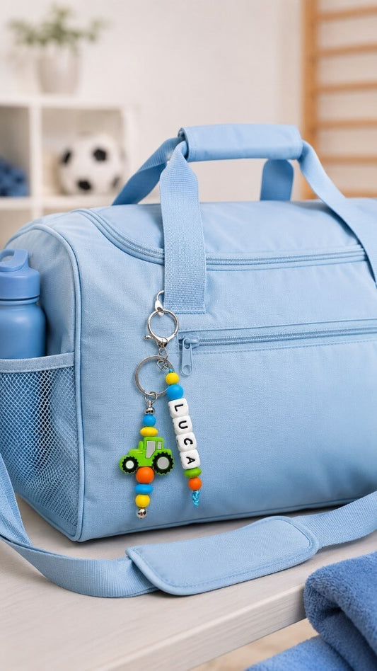 Personalised silicone bead name tag with colourful tractor design for a child's school bag
