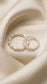 Macro photograph of natural freshwater rice pearls with a deep satin lustre, threaded on a durable stretch cord next to a diamond-cut sterling silver bead.