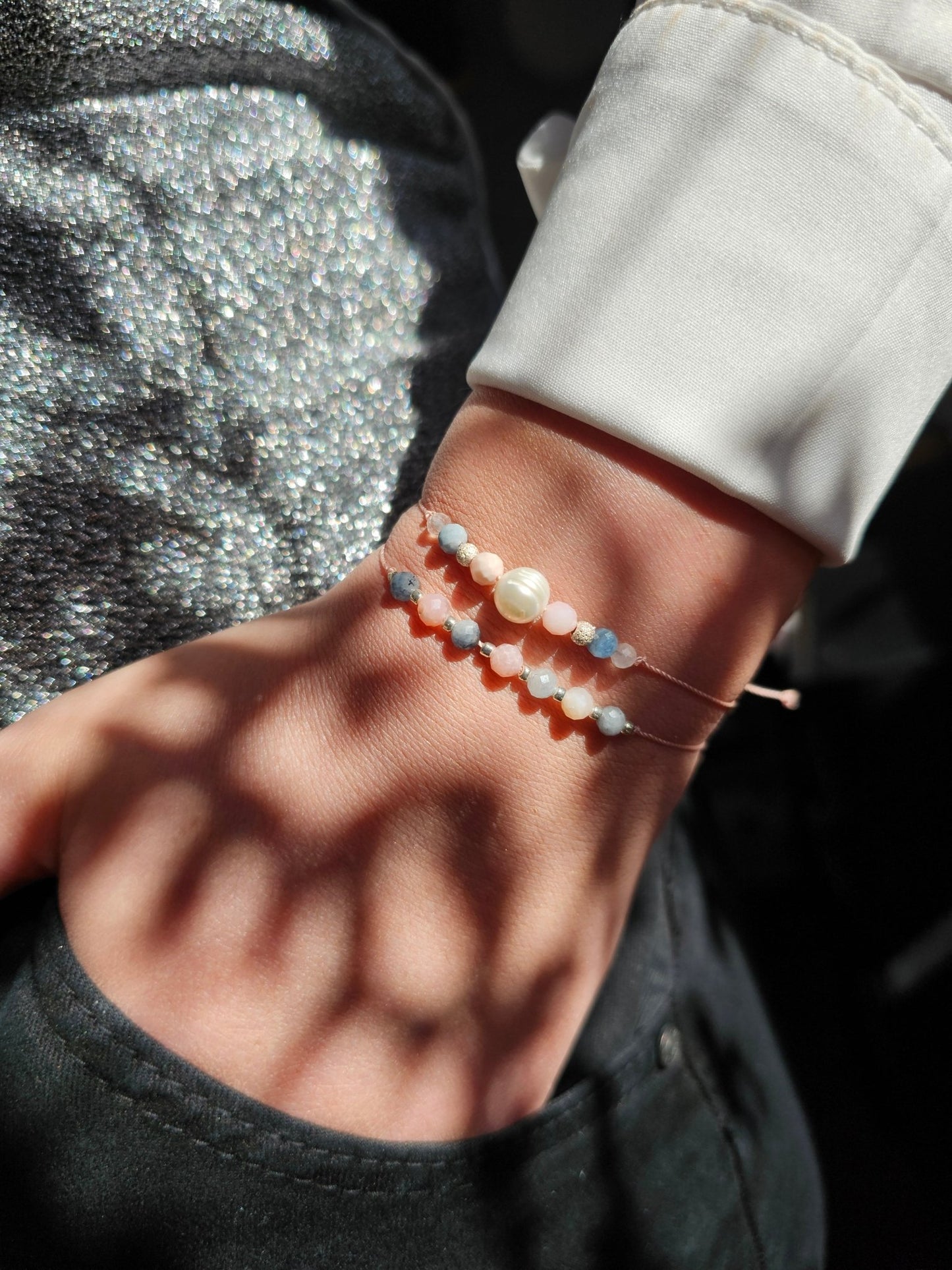 Handmade aquamarine and pink opal bracelet with sterling silver beads. Adjustable cord for comfort. Natural gemstone jewelry promoting calm, love, and creativity.