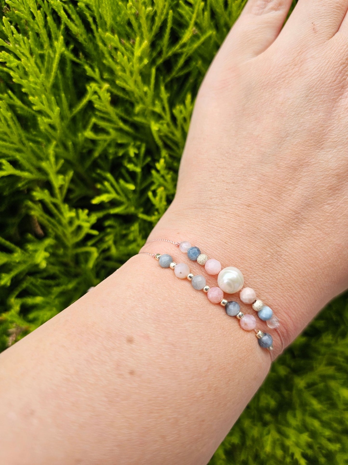 Handmade aquamarine and pink opal bracelet with sterling silver beads. Adjustable cord for comfort. Natural gemstone jewelry promoting calm, love, and creativity.
