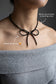 Handmade black tourmaline choker necklace with a delicate beaded bow and 925 sterling silver finish.