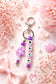 Personalised name bag charm made with soft silicone beads, clipped to a children's school backpack, perfect for identifying their bag at school.

