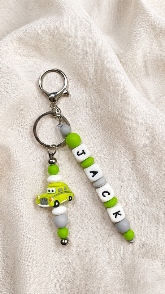 Personalised children’s bag charm with name beads and car charm, perfect for school backpacks, sports bags and nursery bags.