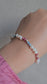 Aurora Bracelet – handmade Irish elastic bracelet with 4mm pearls, aquamarine & rhodonite, sterling silver bead. Healing crystal jewellery symbolising calm, love & purity. Gift pouch included.