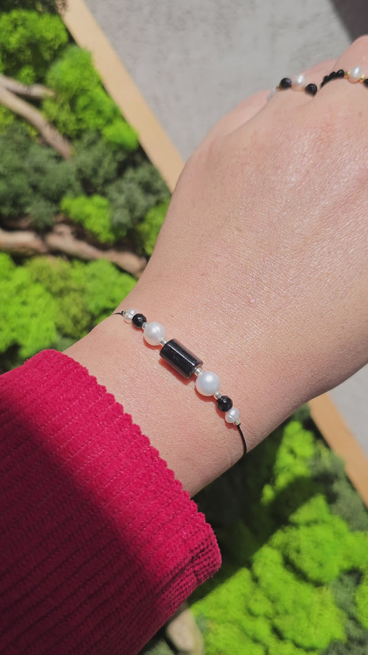 Gift-ready bracelet with pearls, onyx, and black tourmaline beads on elegant black cord.