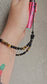 Handmade crystal charm with black onyx and tiger’s eye beads, gold accents, and cord – used as a protective and calming accessory for phone, keys or bag.