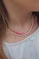 Double-layer choker with freshwater pearls and pink chalcedony on a pink cord from The Strawberry Collection, featuring a 925 sterling silver clasp.